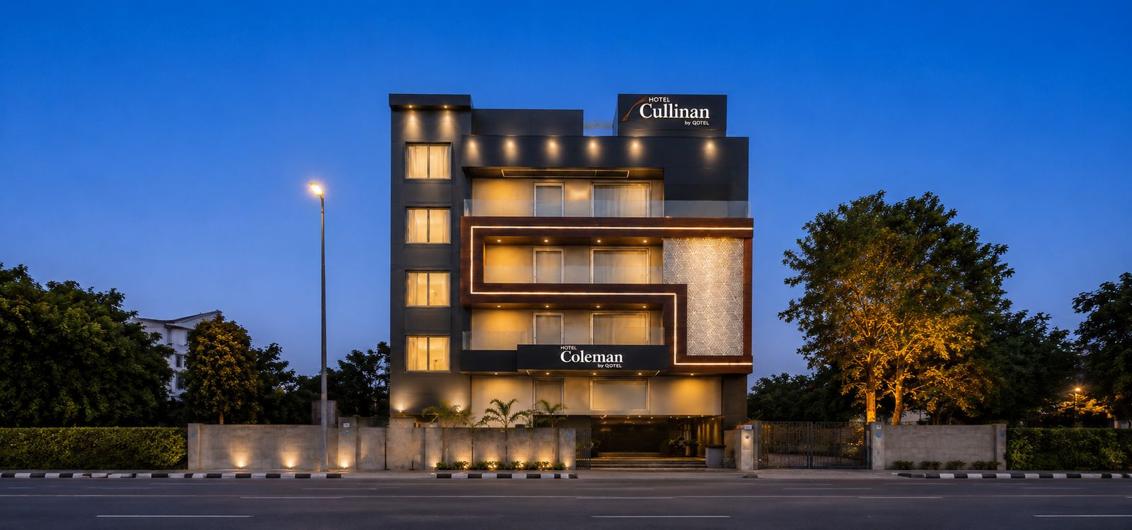 Qotel Signature Coleman, Janakpuri, lit up at dusk